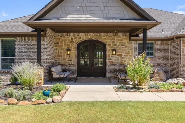 a front view of a house with garden