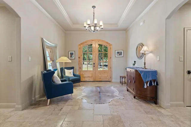 a living room with furniture and a chandelier