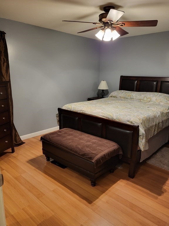 246 Lamont Street Springfield, MA 01119 - Photo 13 of 23 a bedroom with a bed and a chandelier