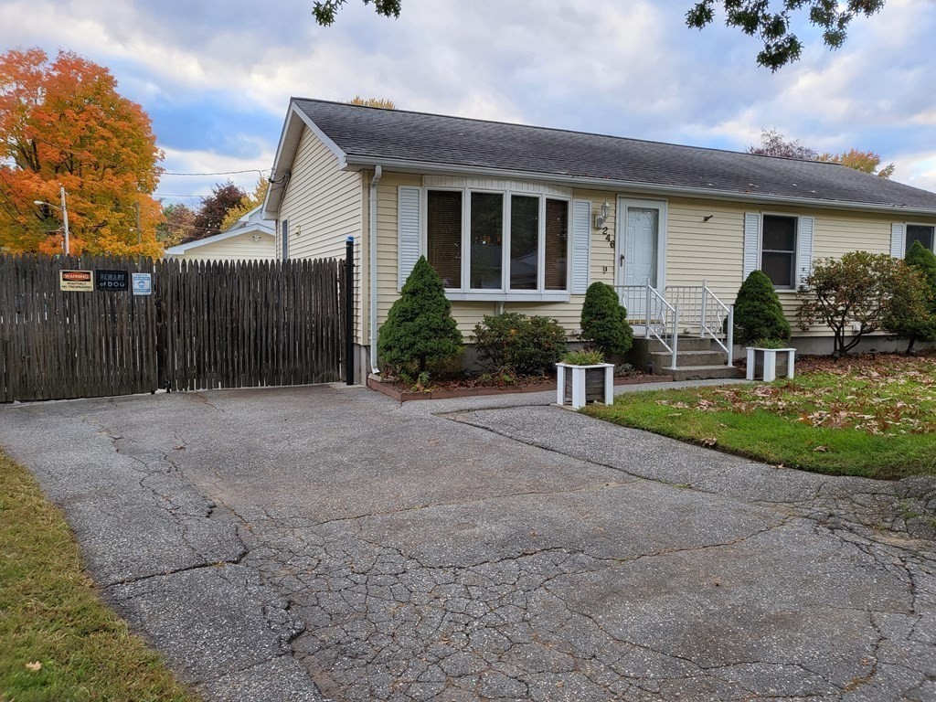 246 Lamont Street Springfield, MA 01119 - Photo 3 of 23 a front view of a house with a yard and garage