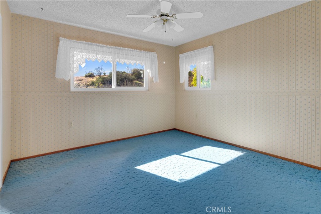 123 19th Street Paso Robles, CA 93446 - Photo 13 of 24 an empty room with windows and ceiling fan