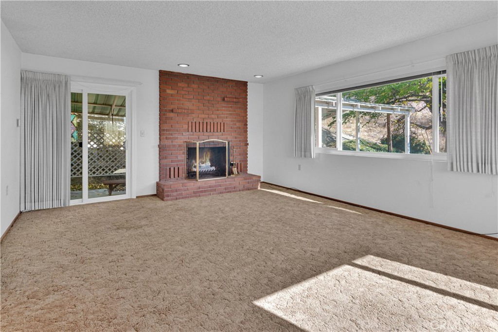 123 19th Street Paso Robles, CA 93446 - Photo 3 of 24 a view of an empty room with a window and a fireplace