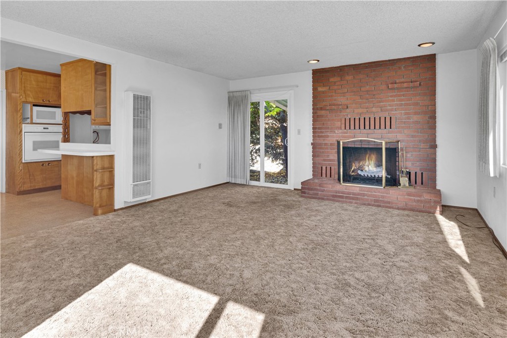 123 19th Street Paso Robles, CA 93446 - Photo 4 of 24 a view of livingroom with fireplace cabinet and window