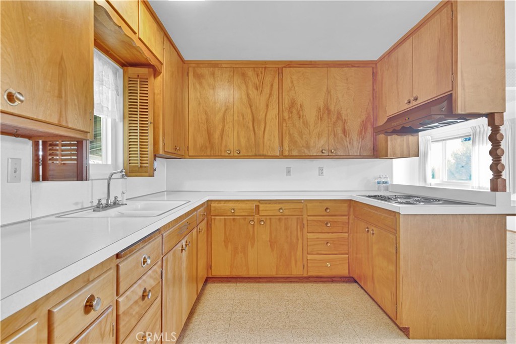 123 19th Street Paso Robles, CA 93446 - Photo 7 of 24 a kitchen with granite countertop a sink dishwasher stove and cabinets