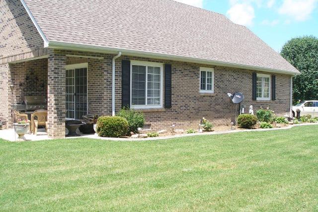 207 Riva Lake Road Winchester, TN 37398 - Photo 19 of 20 Back has a nice patio area notice the beautiful landscaping that surrounds the property
