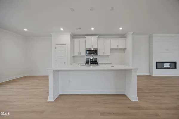 a kitchen with stove and microwave
