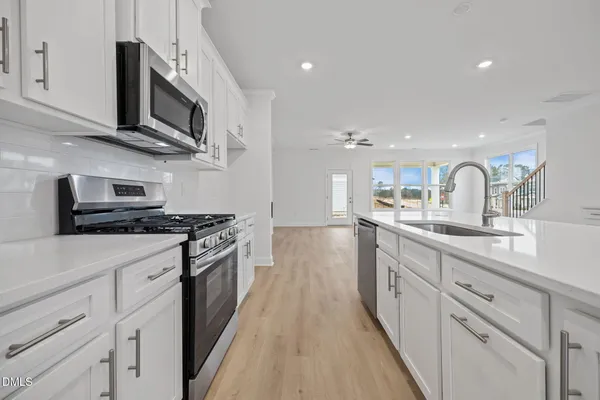 a kitchen with a stove and a microwave