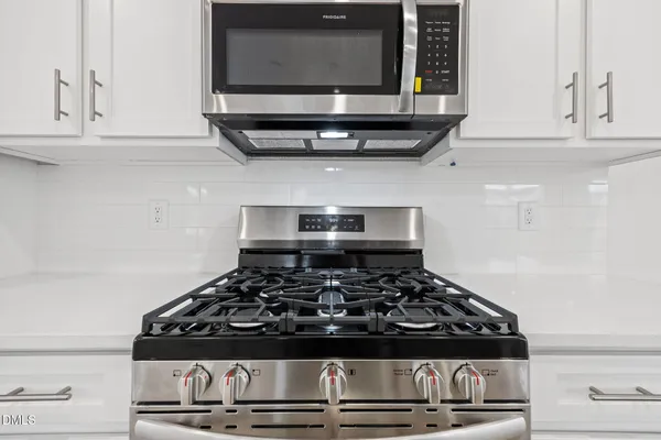 a view of kitchen with wooden floor and electronic appliances