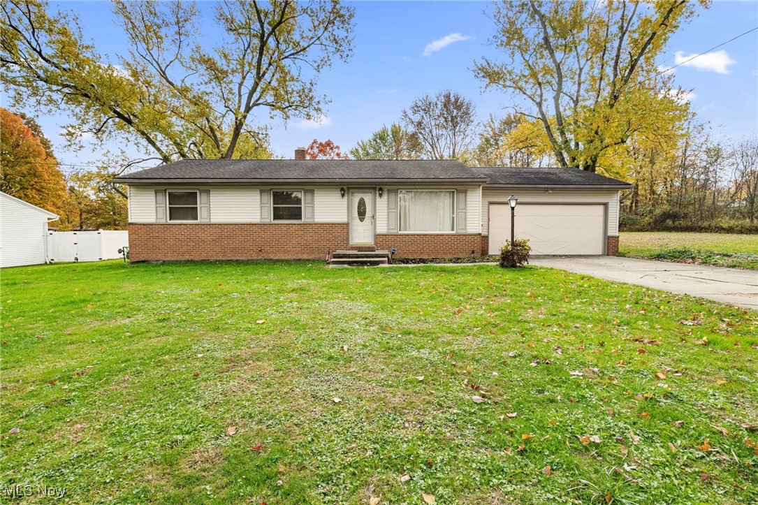 3966 Wadsworth Road Barberton, OH 44203 - Photo 2 of 28 Ranch-style house with brick siding, a front lawn, and a garage
