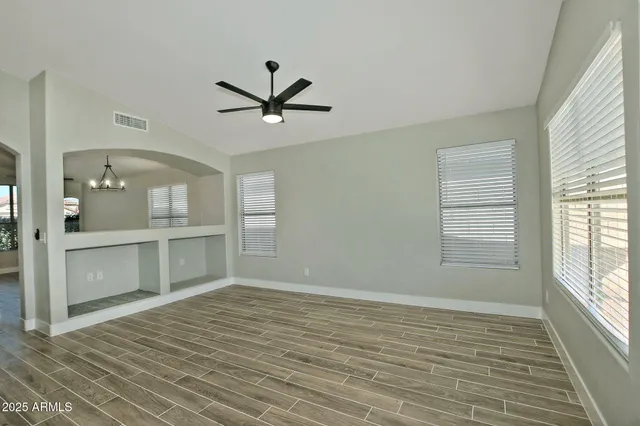 a kitchen with stainless steel appliances cabinets and wooden floor