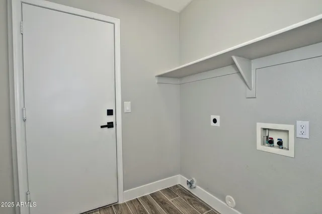 a view of a white house next to a yard with big trees