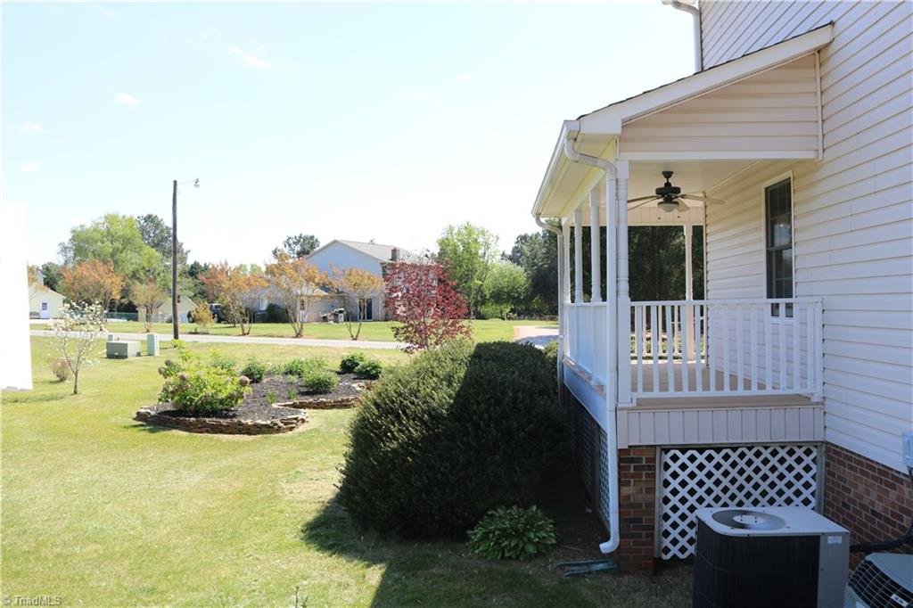 2629 Celeste Road Walkertown, NC 27051 - Photo 2 of 23 Beautiful porch that wraps to the side of house overlooking the beautiful flower garden.