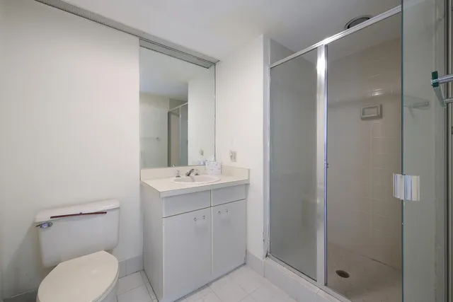 a bathroom with a toilet sink and shower