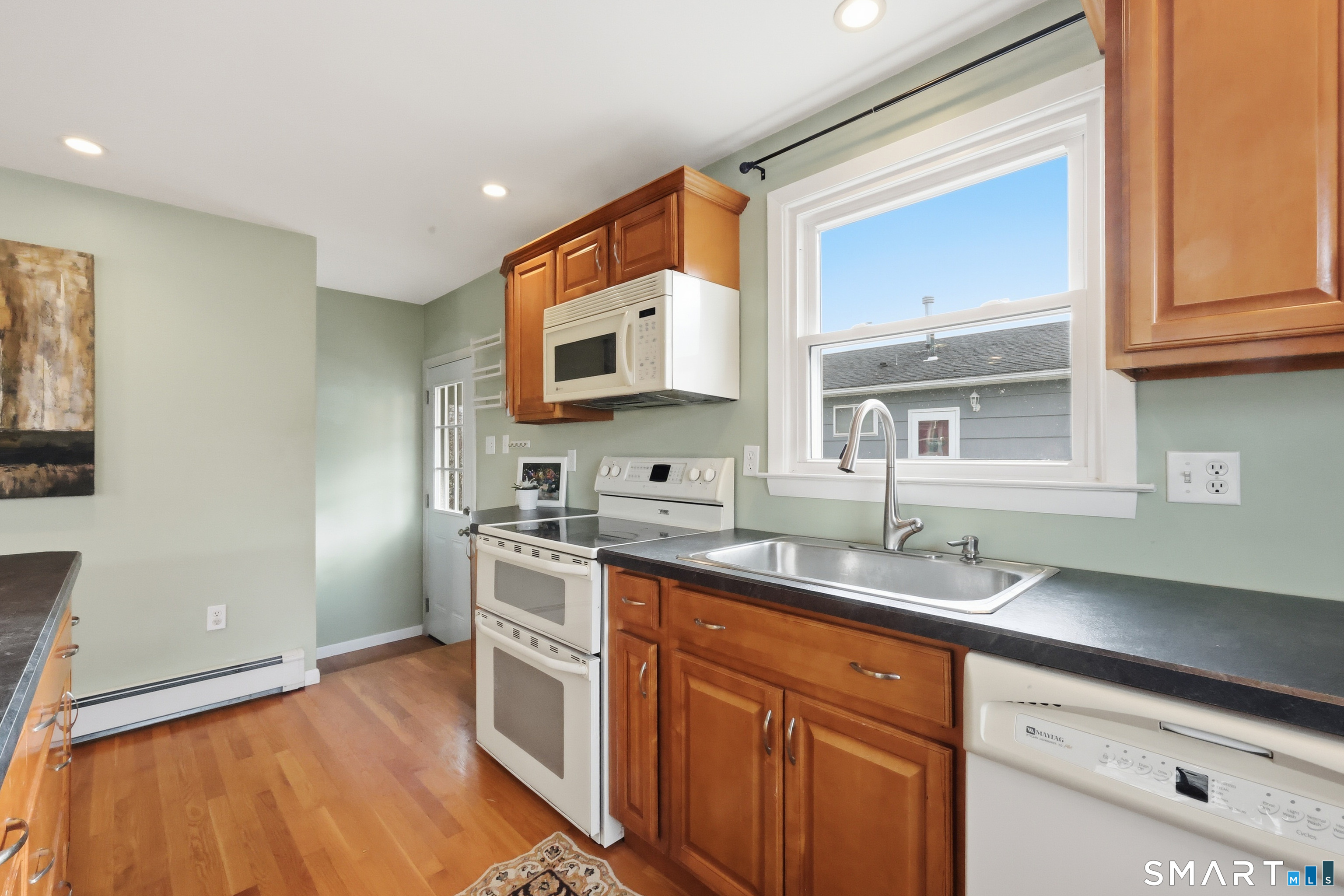 89 North Hoadley Street Naugatuck, CT 06770 - Photo 11 of 28 a kitchen with stainless steel appliances granite countertop a sink stove and cabinets
