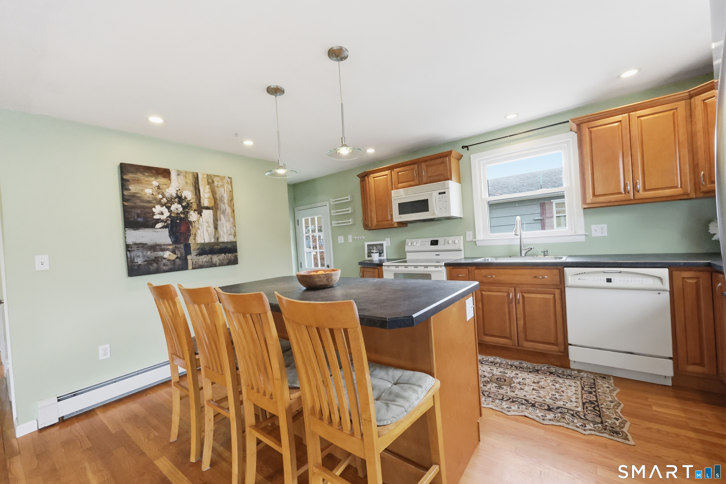 89 North Hoadley Street Naugatuck, CT 06770 - Photo 12 of 28 a open kitchen with stainless steel appliances granite countertop a stove a sink a refrigerator dining table and chairs