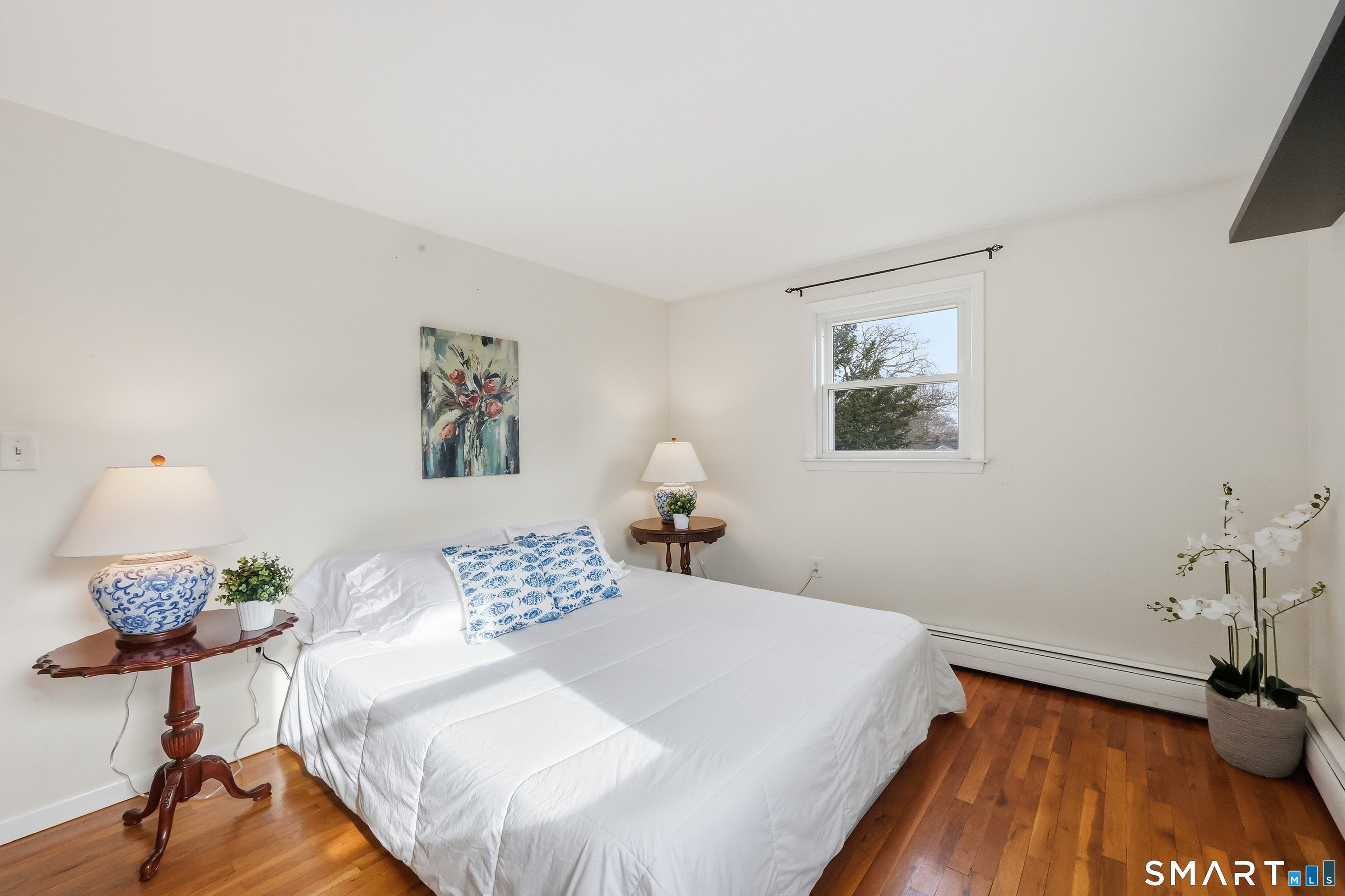 89 North Hoadley Street Naugatuck, CT 06770 - Photo 16 of 28 a bedroom with a bed and a potted plant on the table