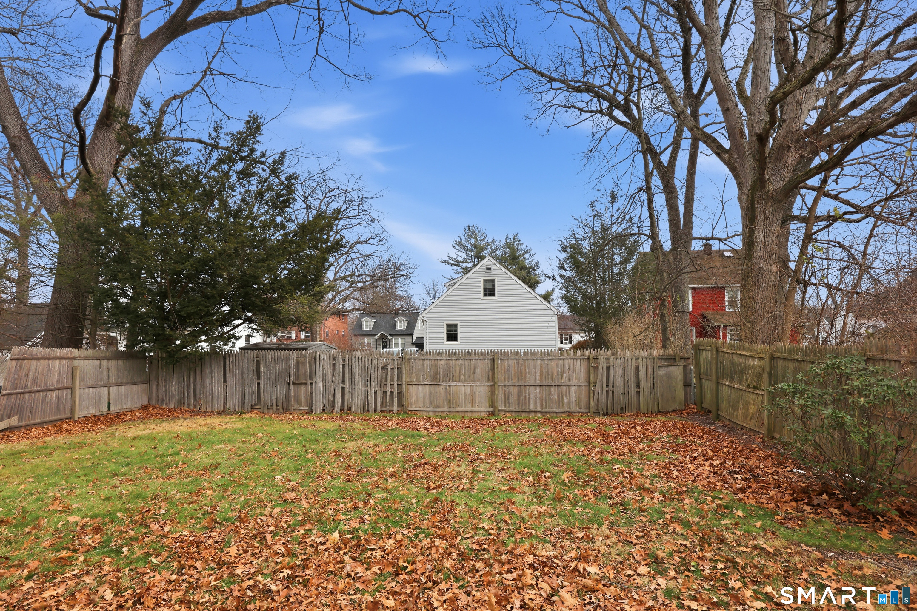 89 North Hoadley Street Naugatuck, CT 06770 - Photo 28 of 28 a view of backyard with wooden fence and large trees