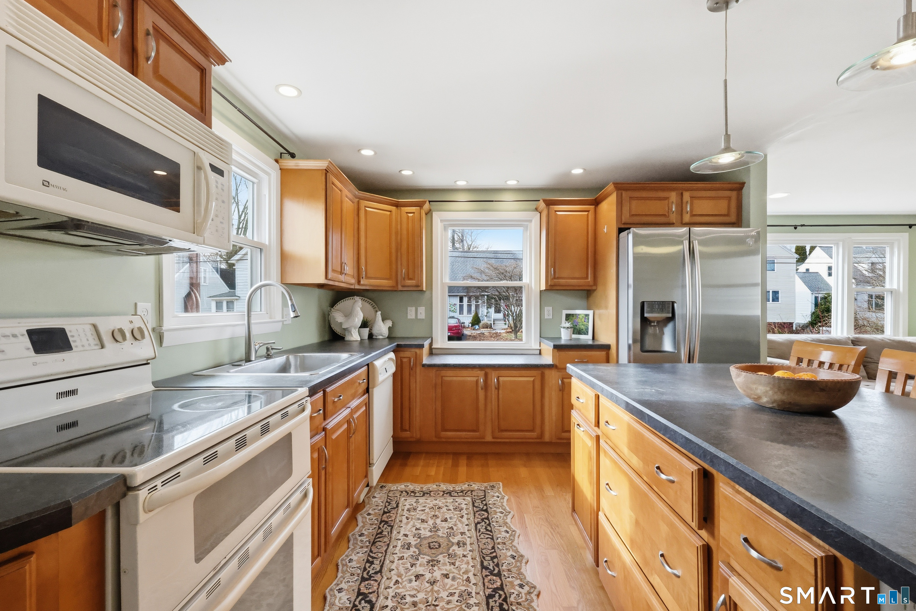 89 North Hoadley Street Naugatuck, CT 06770 - Photo 9 of 28 a kitchen with stainless steel appliances kitchen island granite countertop a sink stove and cabinets