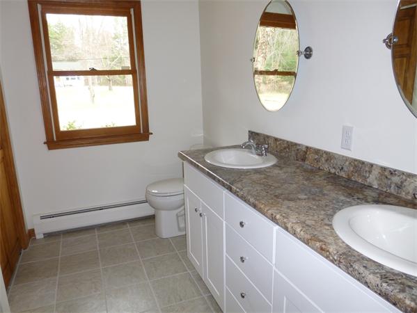 145 Shea Road West Brookfield, MA 01585 - Photo 5 of 11 a bathroom with a granite countertop toilet a sink and a mirror