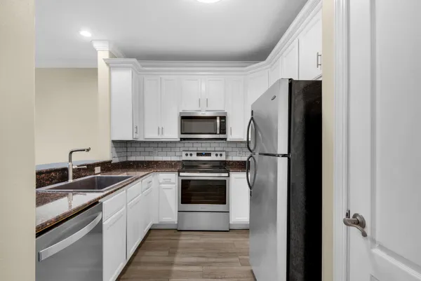 a kitchen with a refrigerator sink and microwave