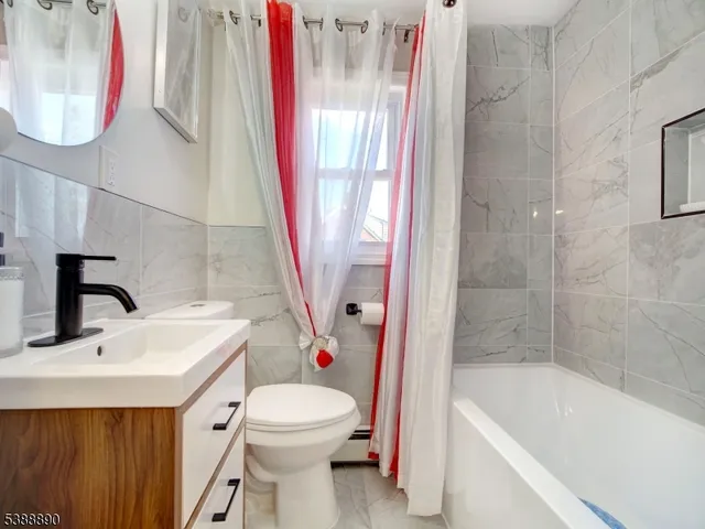 a bathroom with a sink a toilet and a bathtub