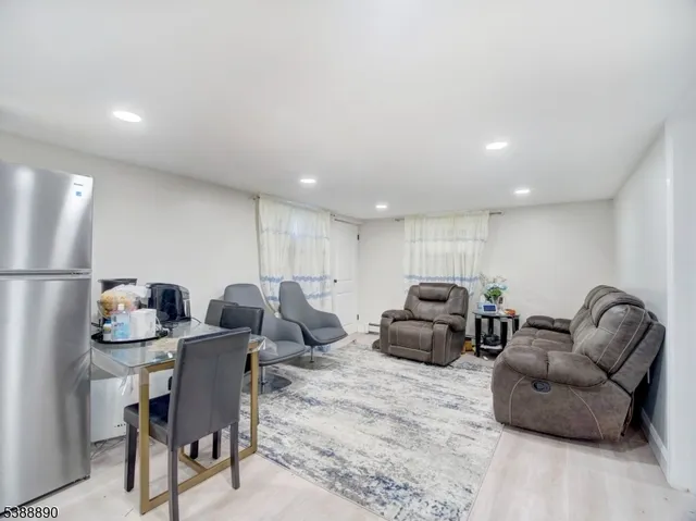 a kitchen with a refrigerator sink and cabinets