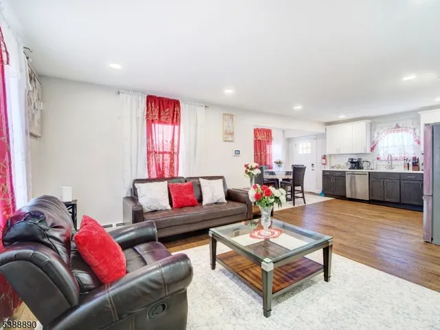 a living room with furniture and kitchen view