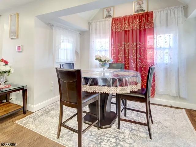 a view of a dining room with furniture and window