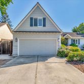 a front view of house with yard and trees around