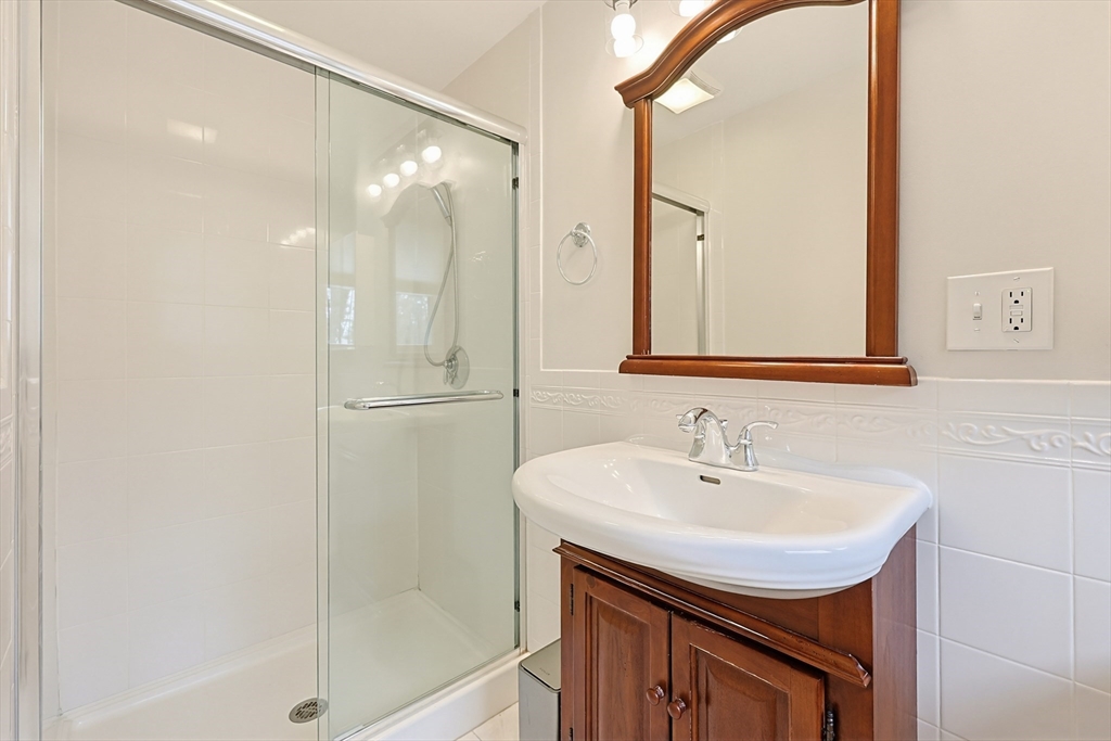 26 Beaver Brook Road Sharon, MA 02067 - Photo 23 of 42 a bathroom with a sink a mirror and a shower