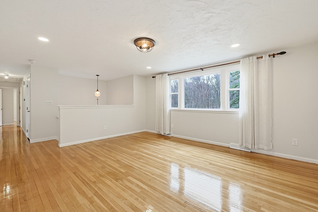 26 Beaver Brook Road Sharon, MA 02067 - Photo 3 of 42 a view of an empty room with wooden floor and a window