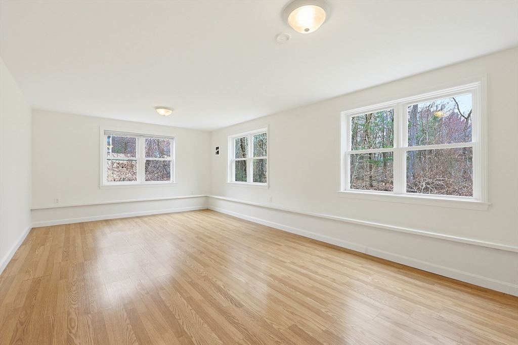 26 Beaver Brook Road Sharon, MA 02067 - Photo 35 of 42 a view of an empty room with wooden floor and windows