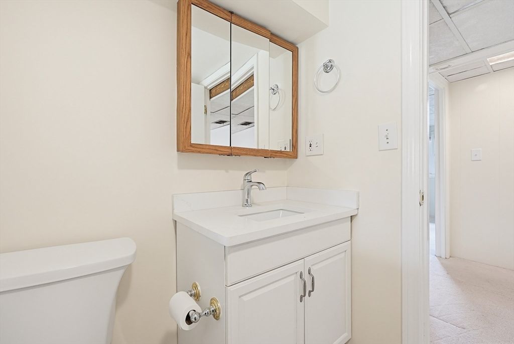 26 Beaver Brook Road Sharon, MA 02067 - Photo 37 of 42 a bathroom with a toilet sink vanity and mirror