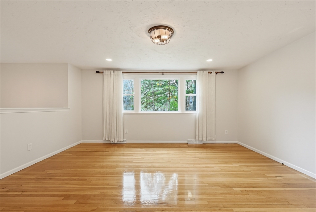 26 Beaver Brook Road Sharon, MA 02067 - Photo 5 of 42 a view of empty room with wooden floor and fan