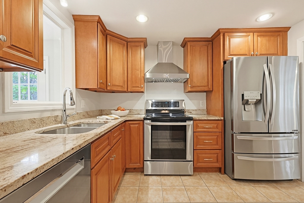 26 Beaver Brook Road Sharon, MA 02067 - Photo 6 of 42 a kitchen with stainless steel appliances granite countertop a refrigerator a stove and a sink