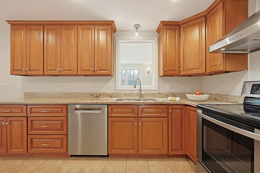 26 Beaver Brook Road Sharon, MA 02067 - Photo 8 of 42 a kitchen with stainless steel appliances granite countertop a sink stove and cabinets