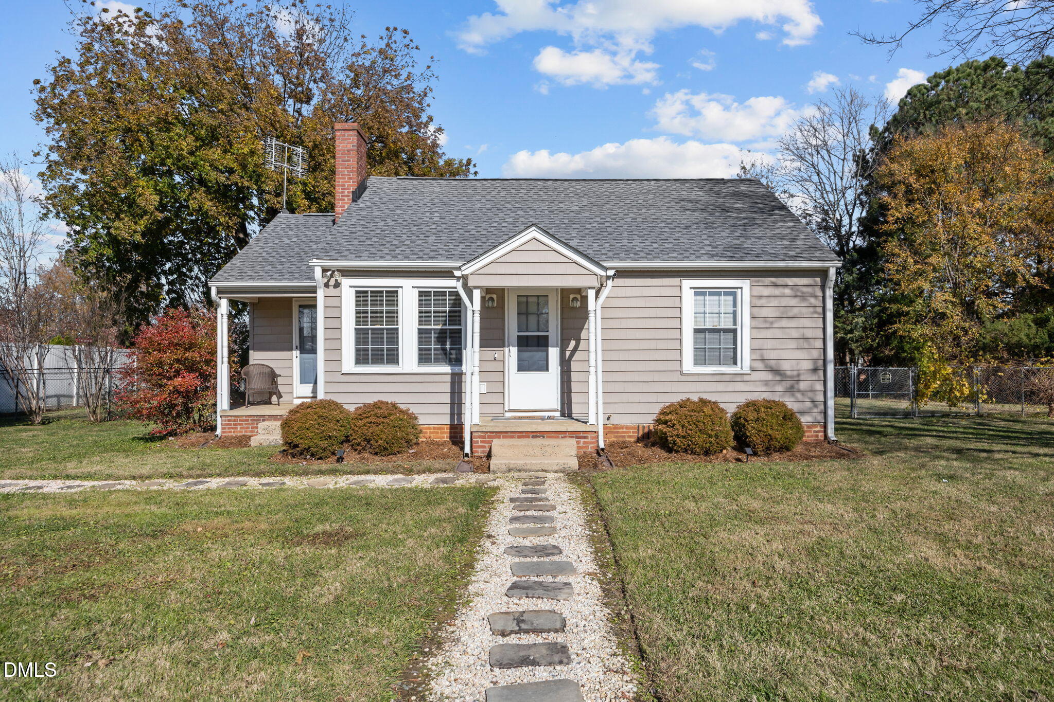 a front view of a house with a garden and yard