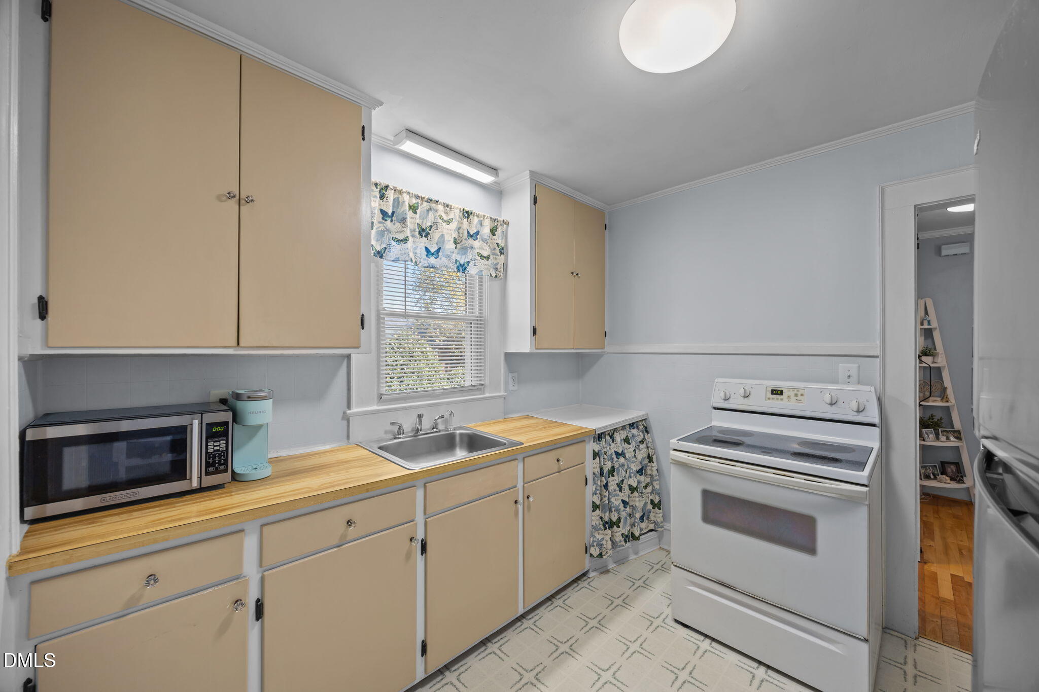 128 Moore Street Graham, NC 27253 - Photo 11 of 45 a kitchen with white cabinets and white appliances