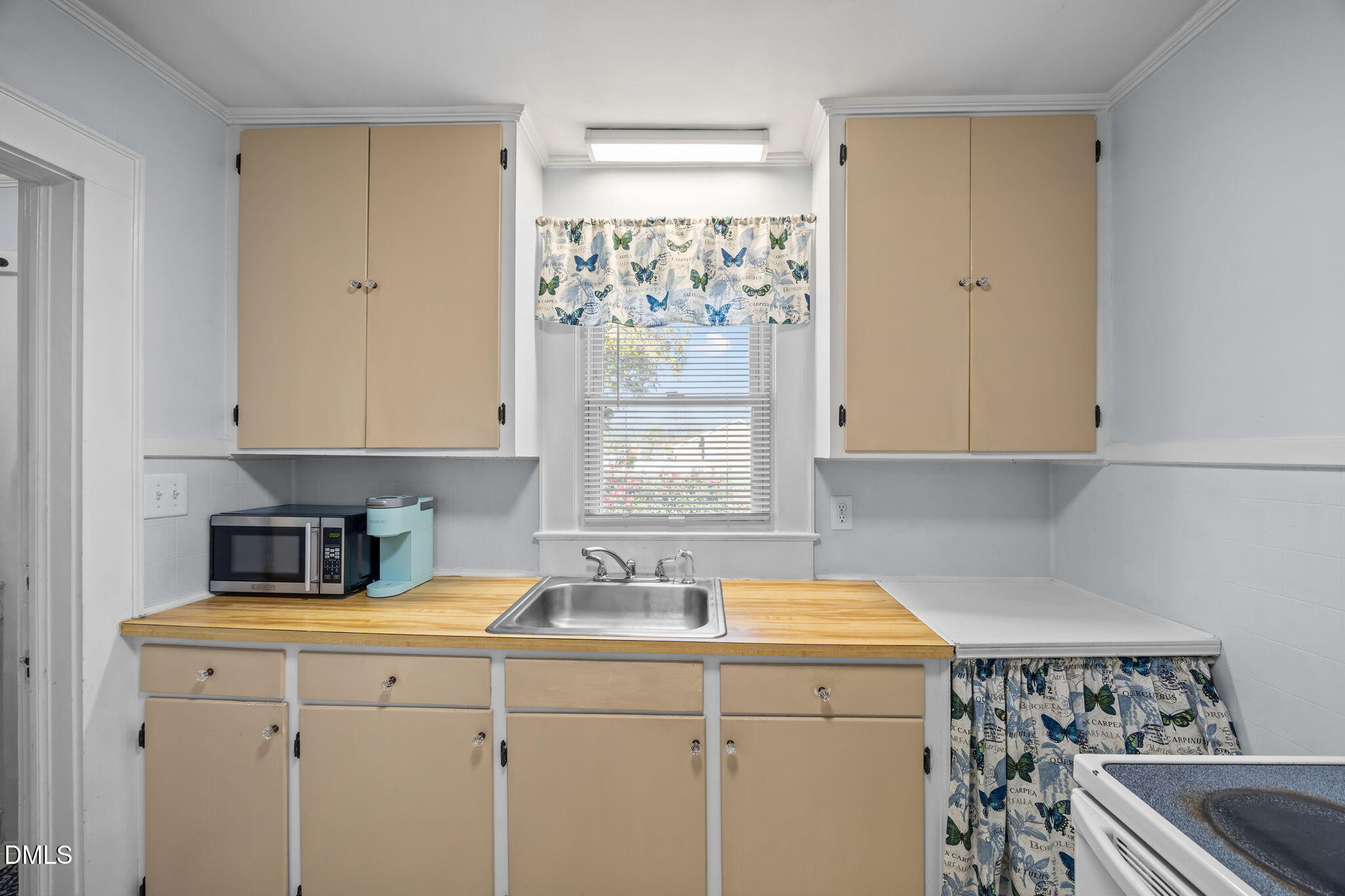128 Moore Street Graham, NC 27253 - Photo 13 of 45 a kitchen with a sink and cabinets