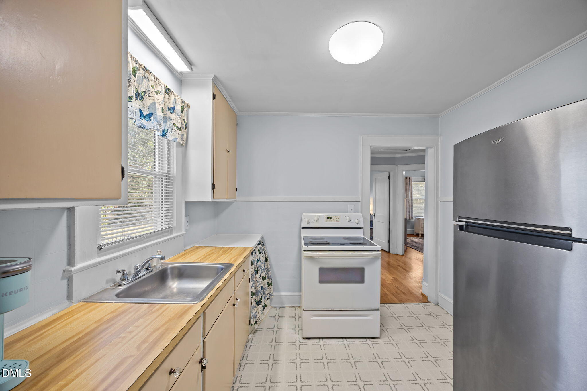 128 Moore Street Graham, NC 27253 - Photo 14 of 45 a kitchen with stainless steel appliances granite countertop a refrigerator sink and stove