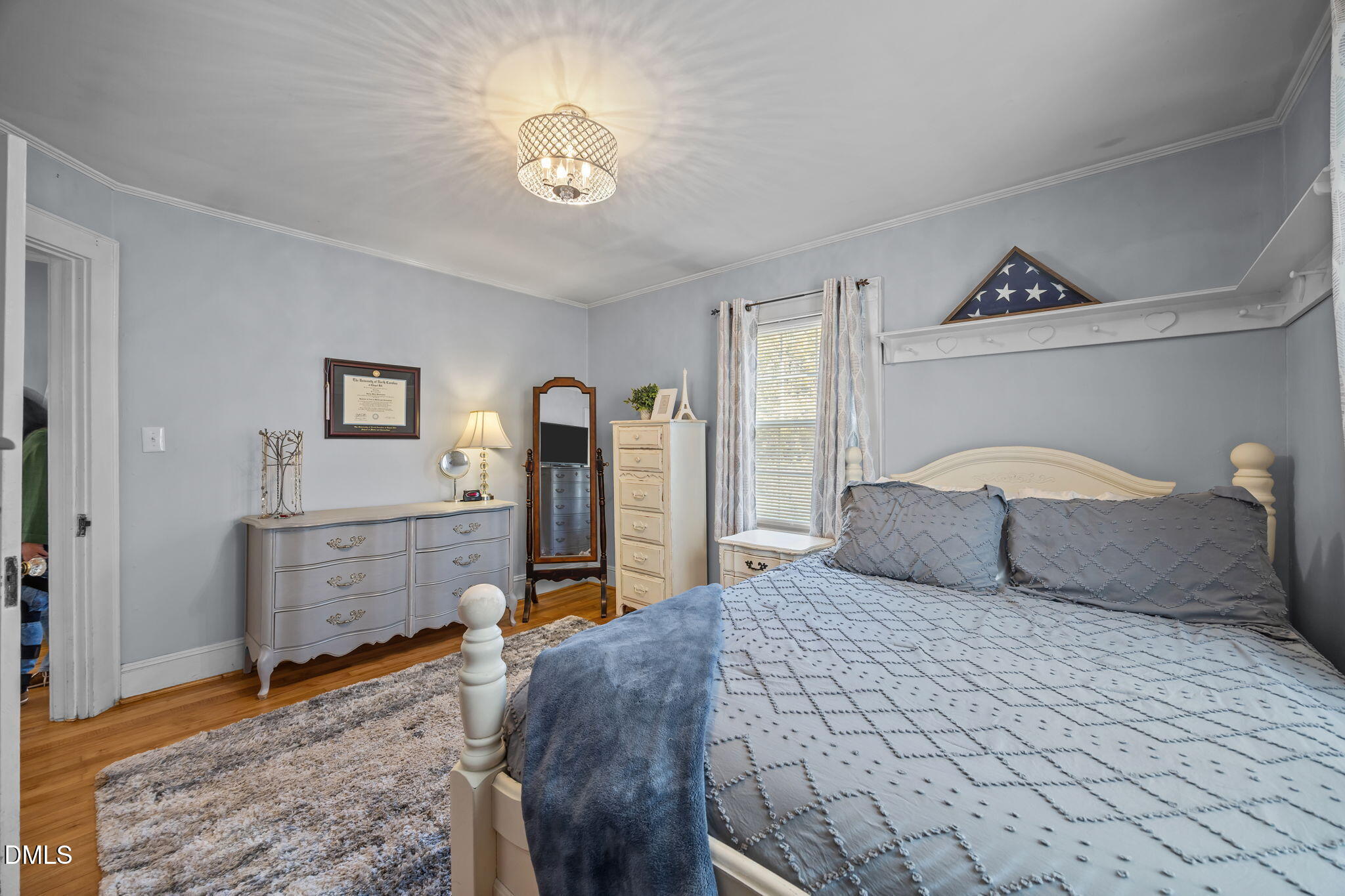 128 Moore Street Graham, NC 27253 - Photo 19 of 45 a bedroom with a bed and a chandelier