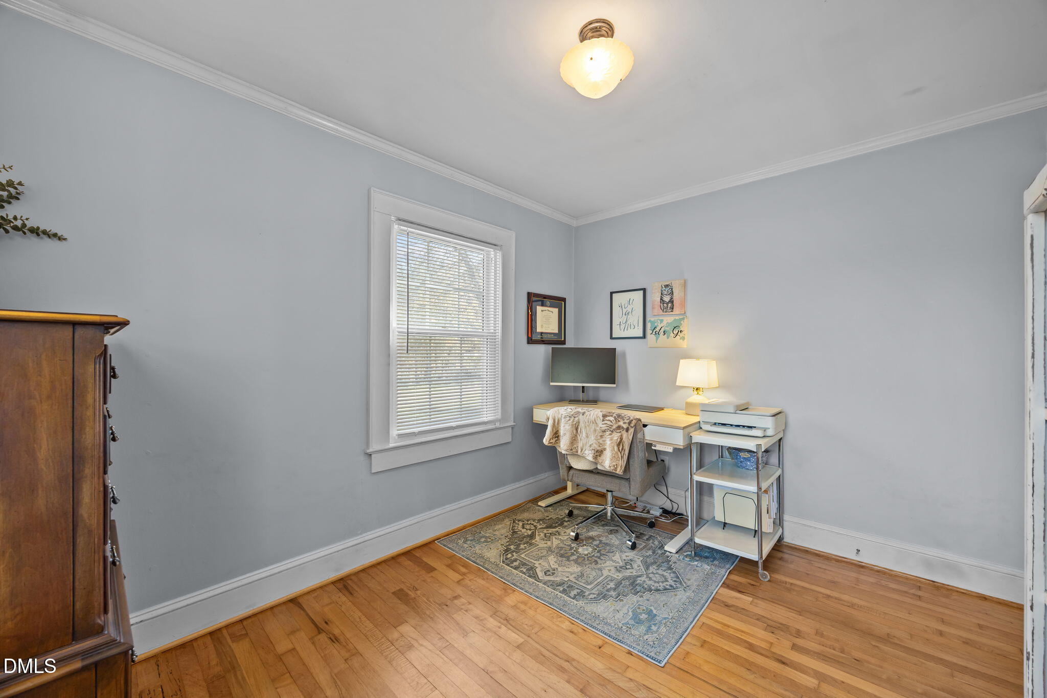 128 Moore Street Graham, NC 27253 - Photo 20 of 45 a workspace with wooden floor and a window