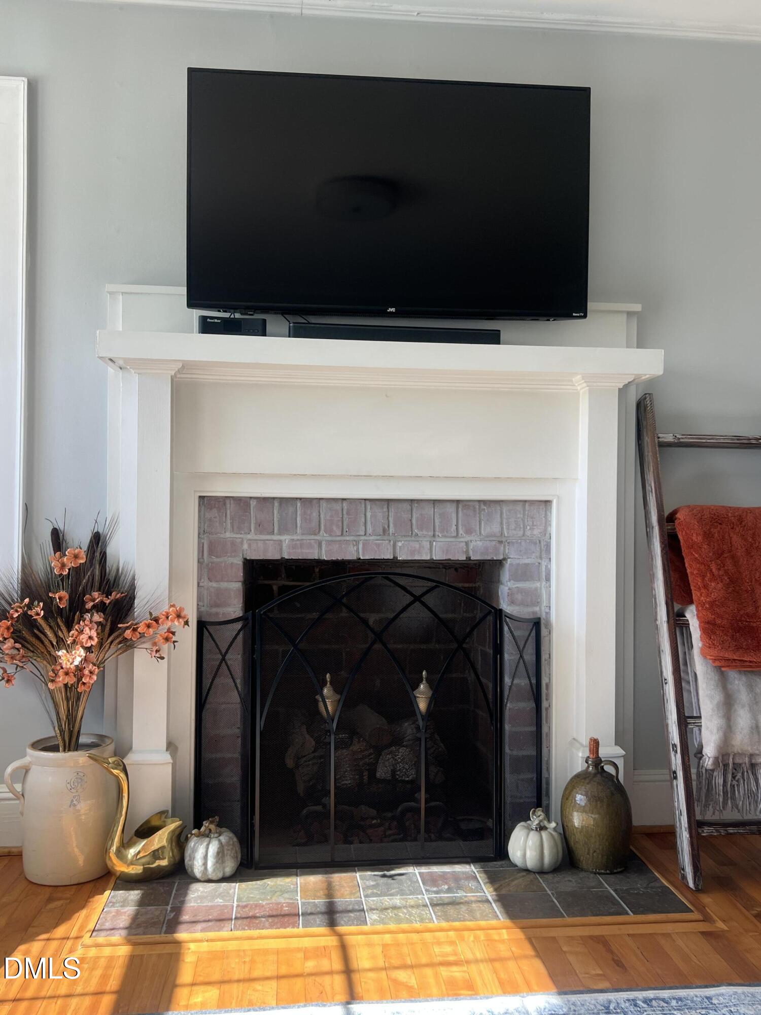128 Moore Street Graham, NC 27253 - Photo 24 of 45 a living room with furniture and a fireplace