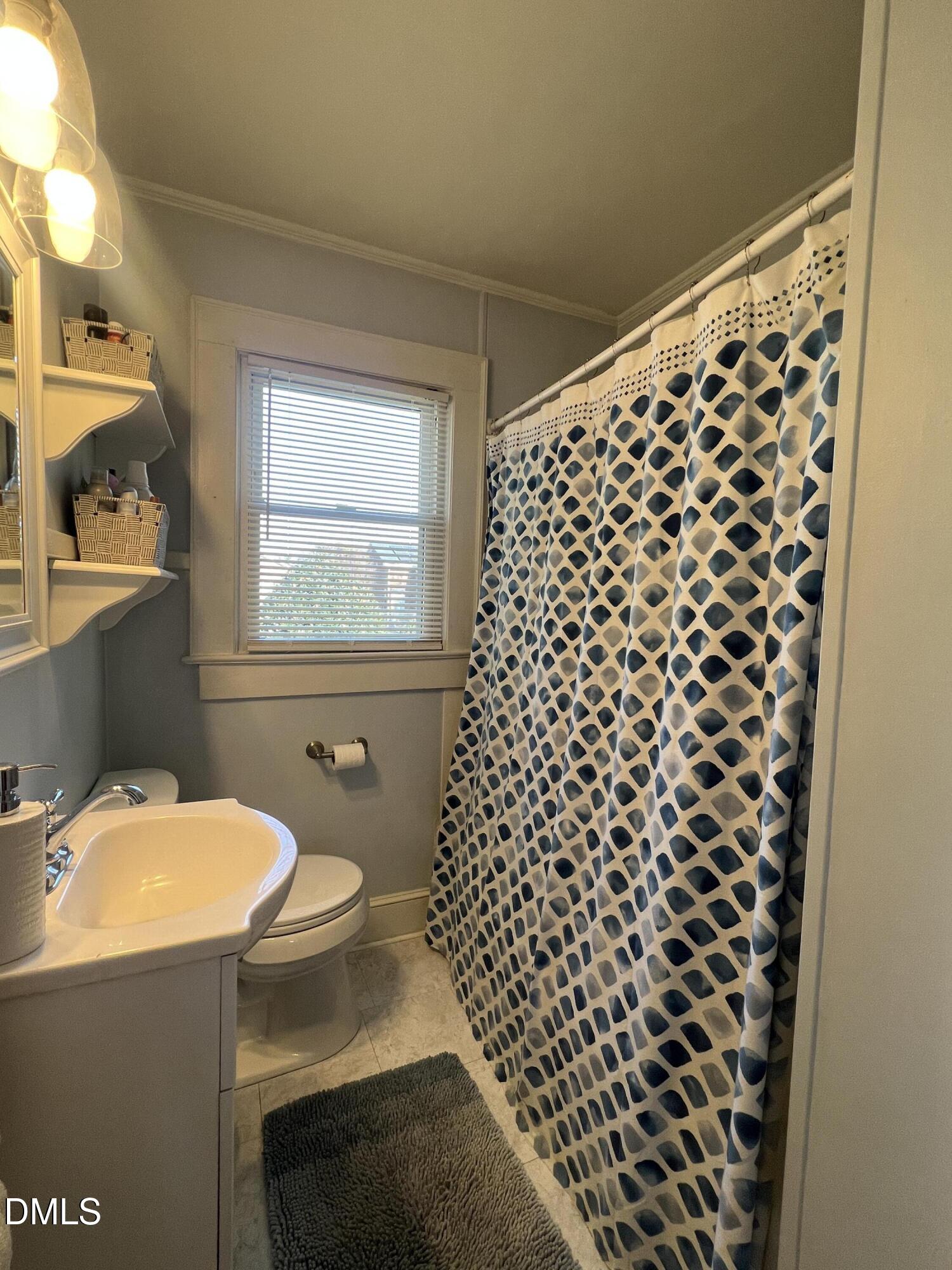128 Moore Street Graham, NC 27253 - Photo 27 of 45 a bathroom with a sink toilet and window