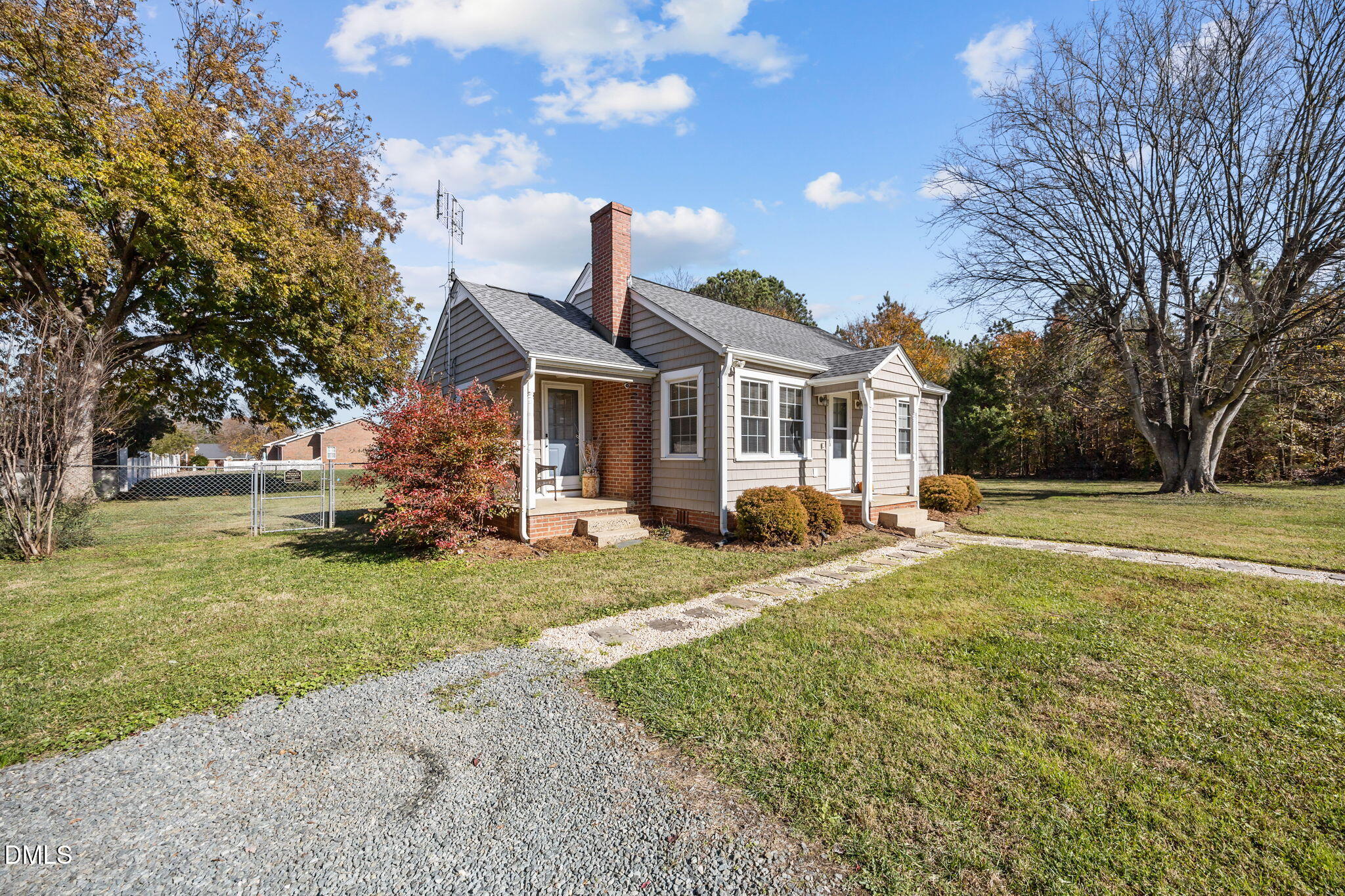 128 Moore Street Graham, NC 27253 - Photo 34 of 42 a front view of a house with a yard and garage