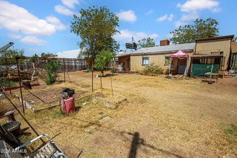 a view of a house with backyard and sitting area