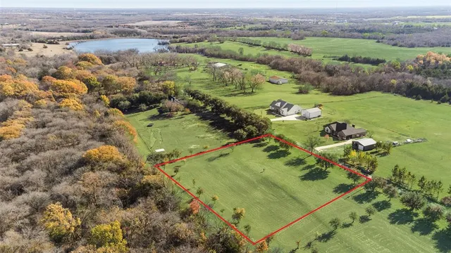 an aerial view of a residential houses with outdoor space