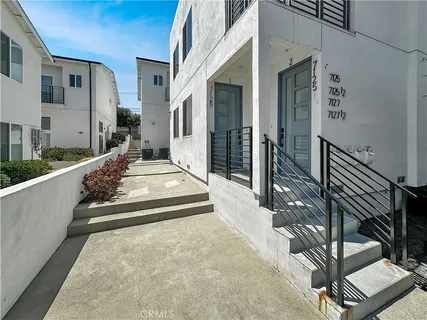 a view of a house with couches and wooden floor