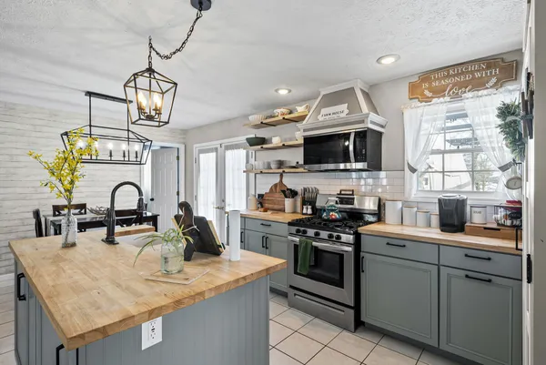 a kitchen with sink a stove and cabinets