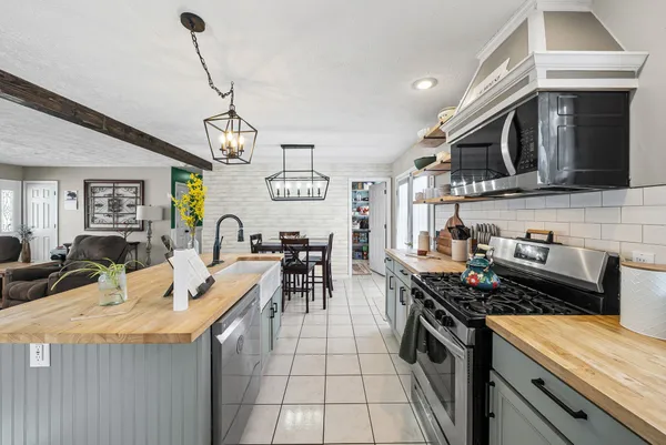 a kitchen with stainless steel appliances granite countertop a stove and a sink